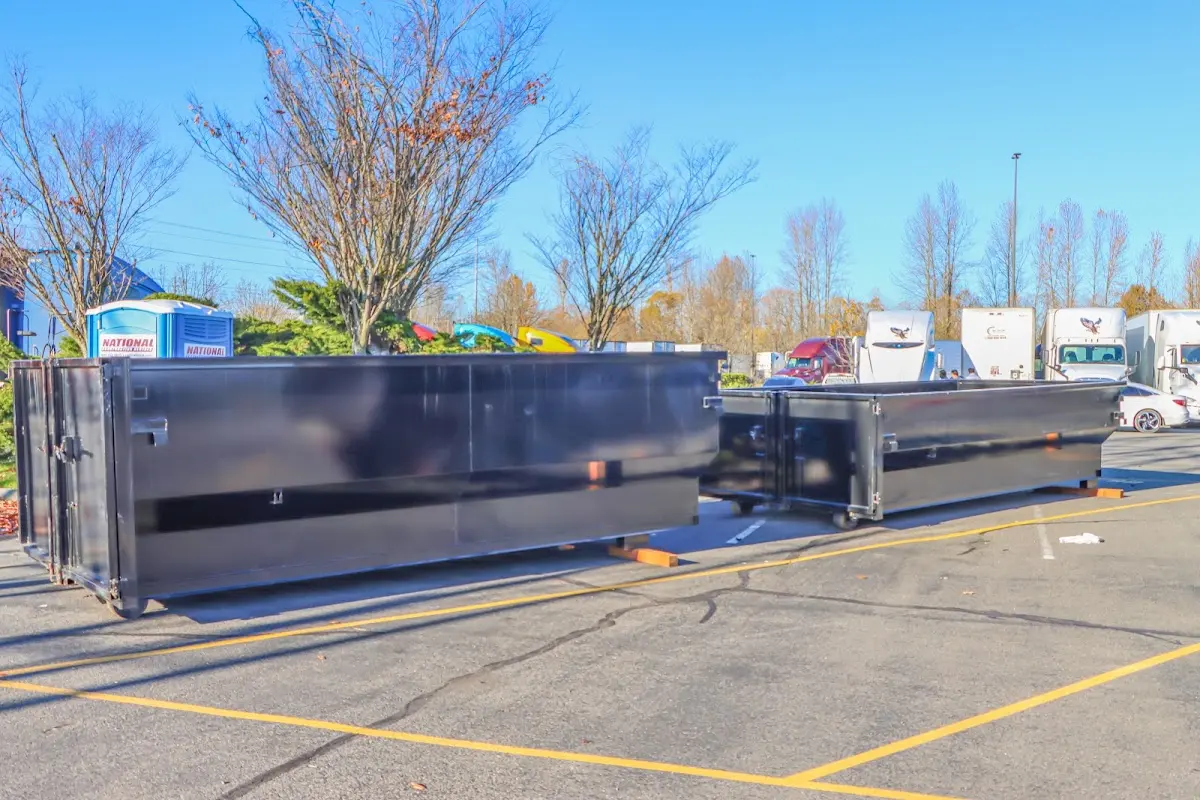 Professional dumpster rental service with roll-off container on residential driveway in Hazle
